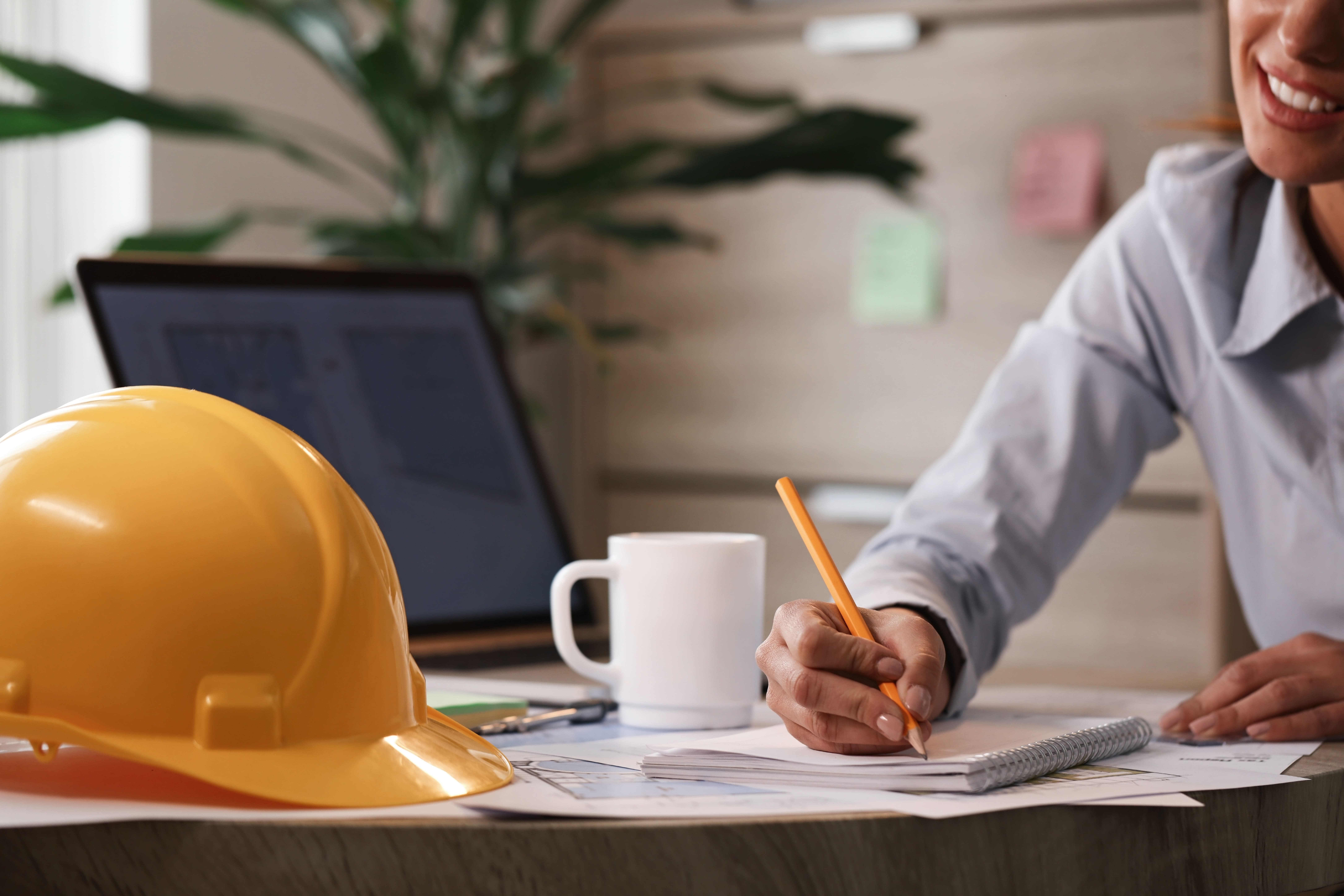 female-engineer-writing-notes-while-working-new-project-office (1)